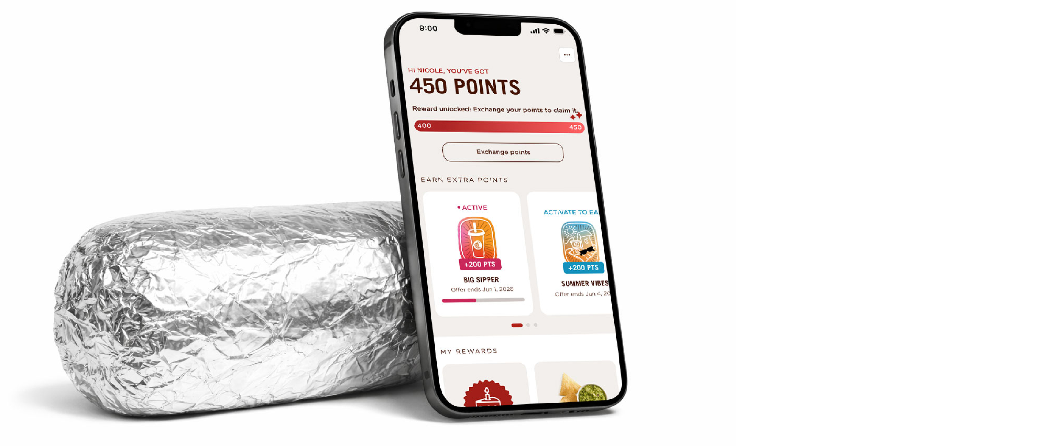 A Chipotle Burrito wrapped in foil behind a smart phone displaying the Chipotle app with a Free Chips reward.